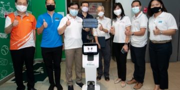 Advisers to East Coast GRC, Deputy Prime Minister Heng Swee Keat, Minister of State Tan Kiat How, and Ms Jessica Tan, and other guests outside the next-generation lift with Temi-Bot.