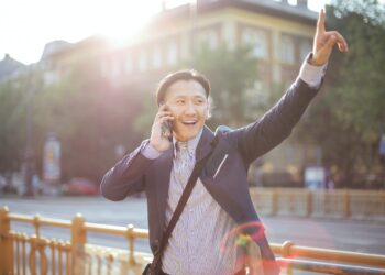 Photo by Andrea Piacquadio: https://www.pexels.com/photo/cheerful-asian-businessman-chatting-on-phone-and-hailing-cab-3760814/