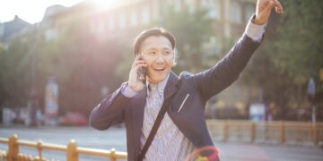 Photo by Andrea Piacquadio: https://www.pexels.com/photo/cheerful-asian-businessman-chatting-on-phone-and-hailing-cab-3760814/