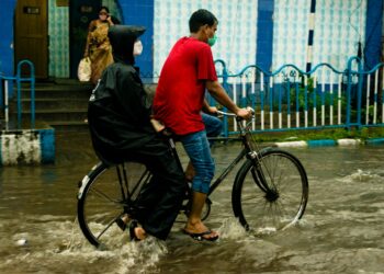 Photo by Biplab Sau: https://www.pexels.com/photo/riding-a-bike-in-the-flood-10872328/