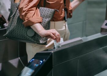 Photo by Liliana Drew: https://www.pexels.com/photo/close-up-of-woman-sliding-the-card-in-a-subway-terminal-8554407/