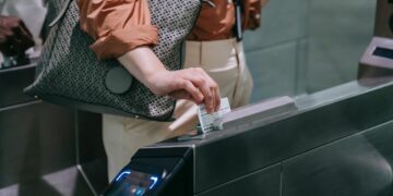 Photo by Liliana Drew: https://www.pexels.com/photo/close-up-of-woman-sliding-the-card-in-a-subway-terminal-8554407/