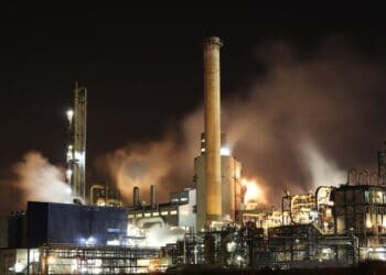 Photo by Loïc Manegarium: https://www.pexels.com/photo/brown-and-white-factory-building-during-night-time-3855962/