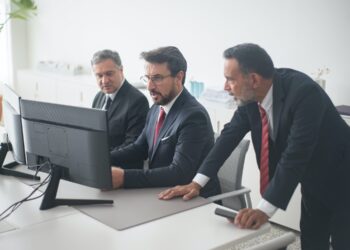 Photo by Kampus Production from Pexels: https://www.pexels.com/photo/three-men-in-black-suit-looking-at-computer-screen-8353776/