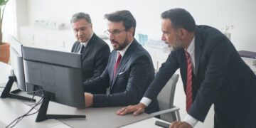 Photo by Kampus Production from Pexels: https://www.pexels.com/photo/three-men-in-black-suit-looking-at-computer-screen-8353776/